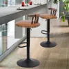 Two bar stools are placed in a modern kitchen or dining area, next to a counter with drinks. Podgląd zdjęcia produktu