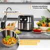 A kitchen counter with an air fryer and various food items. Produktbild-Vorschau