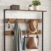 A coat rack with various items hanging on it, including a jacket, hat, bag, and keys. Náhled obrázku produktu