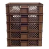 A stack of brown plastic crates on a white background. Produktbild-Vorschau