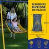 A family on a swing set in a backyard. Anteprima dell’immagine prodotto