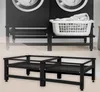 Two identical black metal washing machine stands are shown, one in use with a laundry basket and a washing machine in the background, and another disassembled. Podgląd zdjęcia produktu