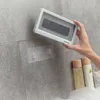 A hand holding a waterproof phone case over a tiled wall in a bathroom, with bottles of toiletries in the foreground. Podgląd zdjęcia produktu