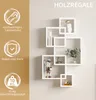 A white geometric wall shelf unit with decorative items displayed on a light gray wall. Voir les images du produit