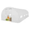 A woman is gardening inside a white greenhouse. Voir les images du produit