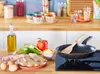 A kitchen counter with ingredients for cooking and a frying pan on a stovetop. Produktbild-Vorschau