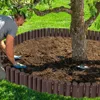 A person is installing a brown garden border around a tree. Náhled obrázku produktu