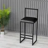 A black bar stool is shown in a room with a gray slatted wall and a potted plant. Anteprima dell’immagine prodotto