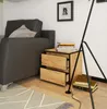A bedside table with two drawers next to a sofa, with books stacked on top and beside it. Produktbild-Vorschau