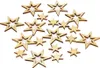 A collection of wooden star-shaped decorations scattered on a white background. Produktbild-Vorschau