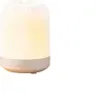 A white and beige aroma diffuser with a ribbed texture, lit from within with a warm yellow light. Produktbild-Vorschau