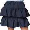A close-up view of a navy blue tiered skirt. Produktbild-Vorschau
