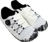 A pair of white athletic shoes with black accents and a camouflage-patterned sole. Náhled obrázku produktu