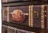A close-up view of a vintage-style suitcase drawer with a globe design and decorative trim. Podgląd zdjęcia produktu