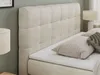 A close-up view of a beige upholstered bed with a tufted headboard and pillows. Produktbild-Vorschau