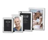 A collection of silver photo frames of varying sizes, some displaying photos of people. Produktbild-Vorschau