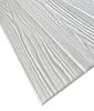 A close-up, angled view of white wood-like panels with a textured grain pattern, laid out diagonally against a white background. Produktbild-Vorschau