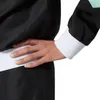 Close-up of a person's arm and torso wearing a black jacket with white cuffs and a white waistband. Produktbild-Vorschau