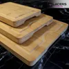 A stack of three bamboo cutting boards with juice grooves, placed on a black marble surface. Produktbild-Vorschau