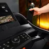 A person's hand is holding a black water bottle over a treadmill. Produktbild-Vorschau
