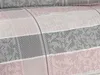 A close-up view of a textile with a plaid pattern. Produktbild-Vorschau