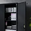 A black metal filing cabinet with its doors open, showing shelves filled with books and binders. Voir les images du produit