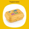 A yellow Tupperware snack box with a safari-themed design featuring cartoon animals and palm trees, set against a white oval shape on a yellow background. Náhled obrázku produktu