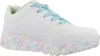 A white sneaker with a colorful heart pattern on the sole and light blue laces, shown from a side view against a white background. Voir les images du produit