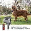 A golden retriever dog stands in a park next to a grooming tool attachment for a vacuum cleaner. Produktbild-Vorschau