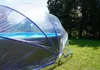 A pool cover is set up over a pool in a grassy area with trees in the background. Produktbild-Vorschau