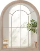 A mirror with an arched frame, reflecting a window with light and shadows, and a plant. Náhľad obrázku produktu