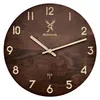 A wooden wall clock with a deer logo and the brand name "Holzwerk". Voir les images du produit