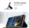 A phone case with a kickstand is shown in use, displaying a movie on the phone screen. Produktbild-Vorschau