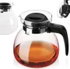 Three glass teapots with black lids, one partially filled with a brown liquid. Produktbild-Vorschau