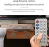 A hand holding a remote control in front of a retro-style music player. Produktbild-Vorschau