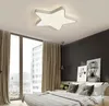 A bedroom with a star-shaped ceiling light, large windows with curtains, and a bed with pillows. Náhled obrázku produktu