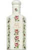 A white perfume bottle with floral decorations. Anteprima dell’immagine prodotto