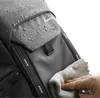 A close-up of a backpack with water droplets on it, being wiped with a cloth. Anteprima dell’immagine prodotto