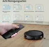 A hand holding a remote control points towards a black robot vacuum cleaner on a wooden floor, with diagrams illustrating different cleaning modes above. Náhled obrázku produktu