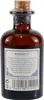 A close-up of the back of a small brown glass bottle of Monkey 47 gin. Anteprima dell’immagine prodotto