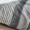 A close-up view of a grey and white striped duvet cover with text printed on it. Produktbild-Vorschau