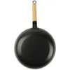 A black cast iron wok with a wooden handle is shown against a white background. Podgląd zdjęcia produktu