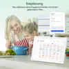 A mother and daughter are in a kitchen, looking at a digital calendar display. Produktbild-Vorschau