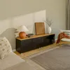A living room scene featuring a lowboard TV cabinet with decorative items and furniture. Voir les images du produit