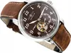 A close-up, angled shot of a men's wristwatch with a brown dial and leather strap. Náhled obrázku produktu