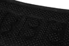 A close-up view of the textured underside of a black belt, showing small raised dots and larger circular protrusions. Náhľad obrázku produktu