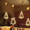 Christmas-themed lights hanging on a window, with a blurred background of a room and a hint of a pillow in the foreground. Podgląd zdjęcia produktu
