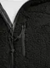 A close-up view of a black fleece jacket with a zipper and a pocket. Produktbild-Vorschau