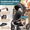A baby in a stroller being pushed by an adult. Produktbild-Vorschau
