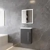 A modern bathroom vanity with a dark gray cabinet and white countertop, set against a gray marble-tiled wall. Produktbild-Vorschau